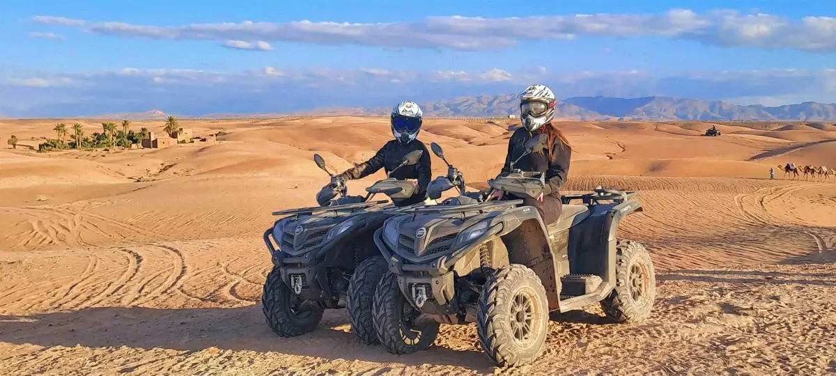 Panoramic view of quad bikes crossing the rolling hills of the Agafay Desert